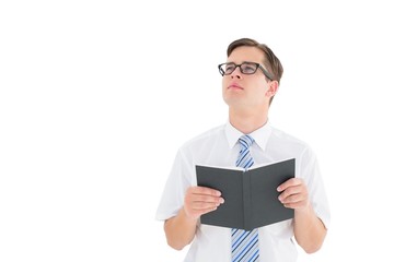 Geeky businessman reading from book