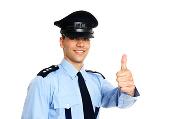 Smiling young policeman in uniform shows you thumb up