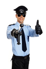 Young smiling policeman in sunglasses shows you thumbs up