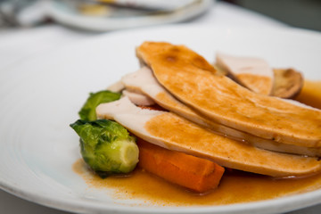 Sliced Turkey on Plate with Gravy and Brussel Sprout