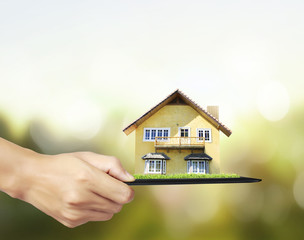 house on tablet in hands