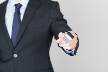 handsome businessman pays with a credit card