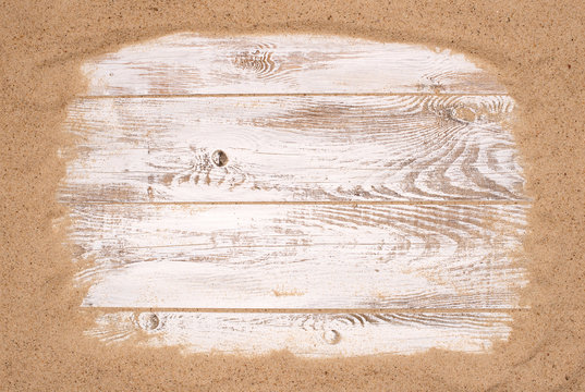 Beach sand on wooden background with copy space