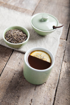 Tea set with tea crop and mug. Selective focus.
