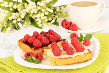 Delicious toast with raspberries on table close-up