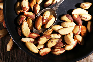 Tasty brasil nuts in pan, close up