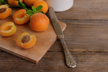 Ripe apricots with green mint leaves