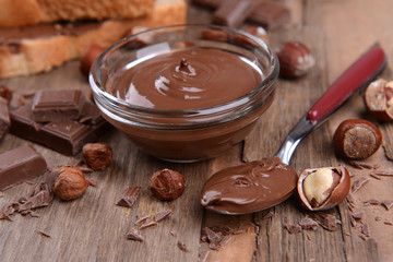Sweet chocolate cream in bowl on table close-up