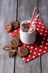 Milk cocktail with chocolate cookies on table close-up