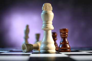 Chess board with chess pieces on purple background