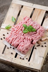 Raw ground meat with basil, pepper and garlic, vertical shot