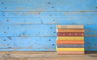 colorful books on a wooden shelf, free copy space