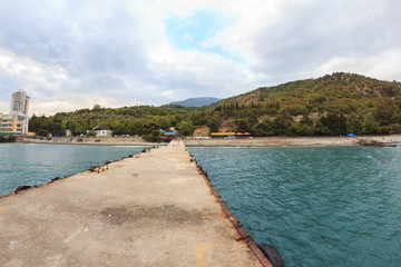 Pier in sea with mountains