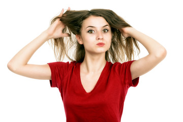 young woman pulling damaged hair both hands