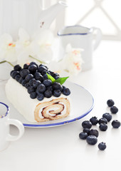 Cake roll with blueberry and cream cheese, selective focus
