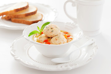 Soup with chicken meatballs and vegetables, selective focus