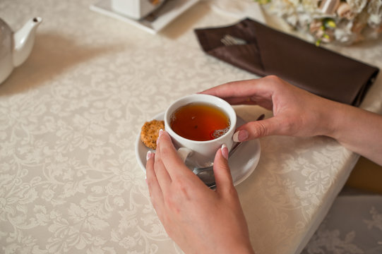 Cup of tea and hands.
