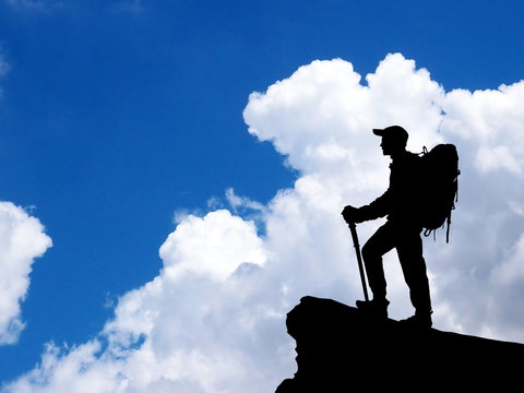 Man standing on summit of mountain.