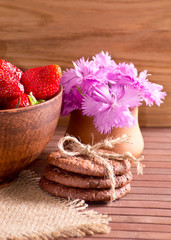 Still life of strawberries, cookies and cloves