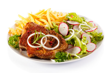 Grilled steak, French fries and vegetables