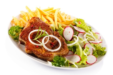 Grilled steak, French fries and vegetables