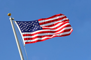 American Flag Blowing in the Wind with Blue Sky