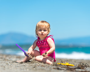 little cute girl playing in the sand