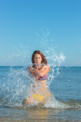 Beautiful woman jumps out of the sea  big splash