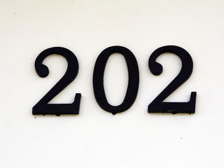 house number two hundred and two on a white wall