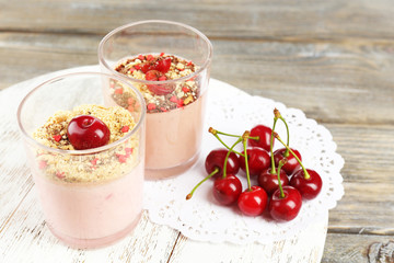 Tasty cherry dessert on wooden table