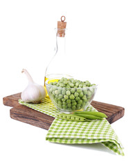 Fresh peas in glass bowl on wooden board, isolated on white
