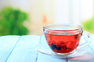 Fruit red tea with wild berries in glass cup,