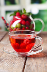 Fruit red tea with wild berries in glass cup,