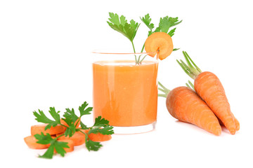 Glass of carrot juice with fresh carrots and parsley isolated