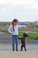 Little girl training a dog