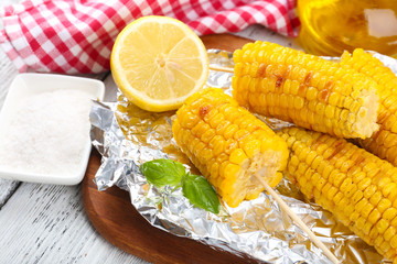 Grilled corn cobs on table, close-up