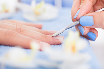 Manicurist Removing Cuticle From Nail