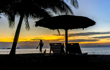 Gazebo and people silhouette with sunset background