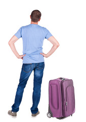 Back view of young man traveling with suitcas.