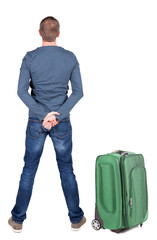 Back view of young man traveling with suitcas.