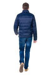 Back view of going  handsome man in jeans and jacket.