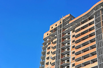 Building construction site work against blue sky