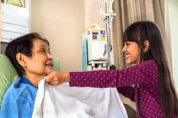 Granddaughter caring about ill grandmother