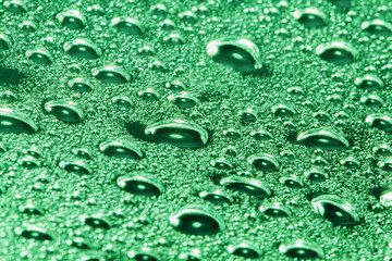 green water drops on the surface