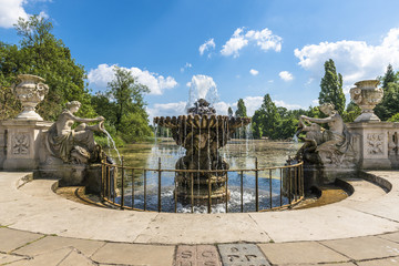 old stone fountain with flowing water in Hyde Park, London