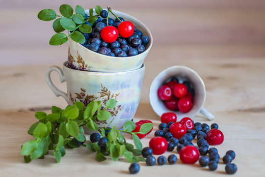 Bluberry and cherry still life on light background