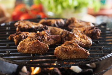 Grilling chicken wings on barbecue grill
