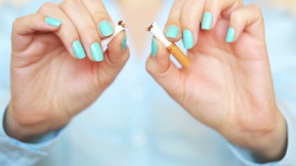 Woman breaks a cigarette