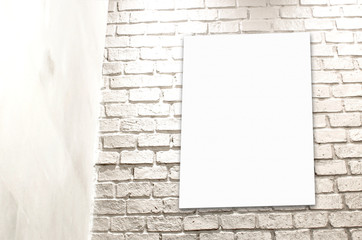 Poster hanging at white brick wall at the conner of room,templat