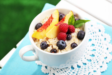 Oatmeal in cup with berries